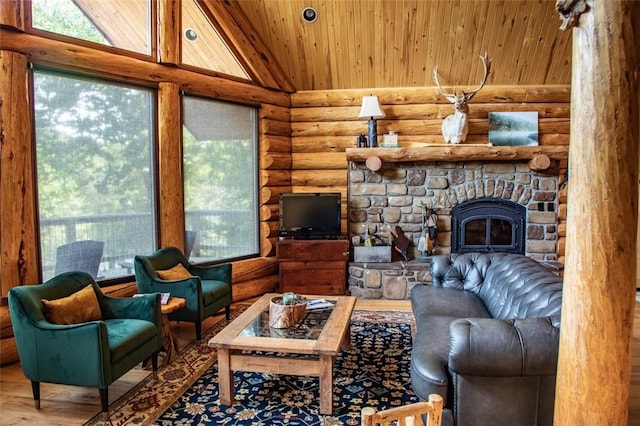 living room with hardwood / wood-style flooring, rustic walls, high vaulted ceiling, a stone fireplace, and wooden ceiling