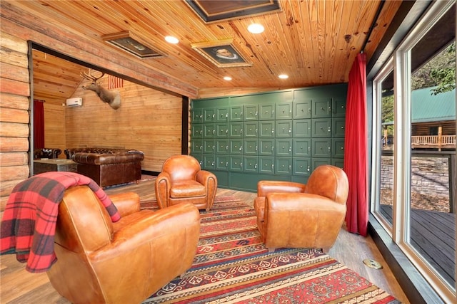 cinema room with mail boxes, wood walls, vaulted ceiling, wooden ceiling, and hardwood / wood-style flooring