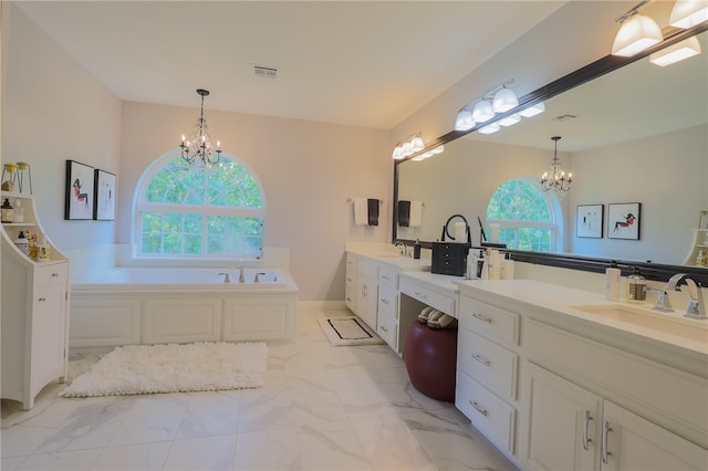 bathroom with vanity, a chandelier, and a washtub