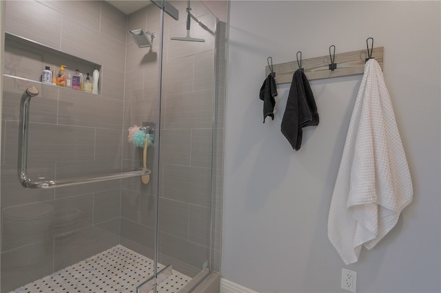 bathroom featuring a shower with door