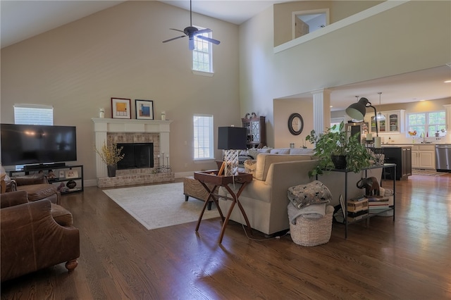 living room featuring high vaulted ceiling, dark hardwood / wood-style flooring, and a wealth of natural light