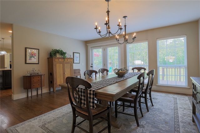 dining space featuring a chandelier, a wealth of natural light, and dark hardwood / wood-style floors