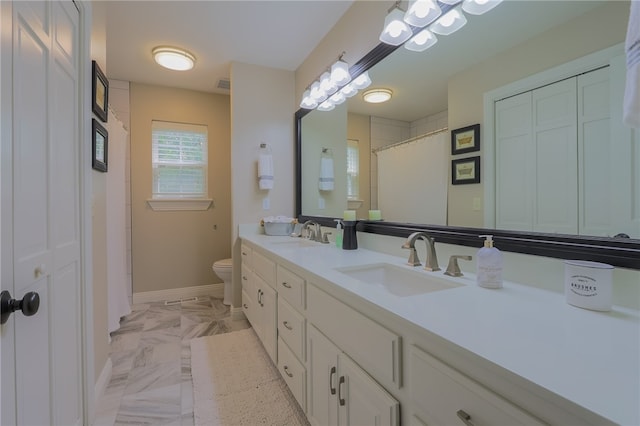 bathroom featuring toilet and vanity