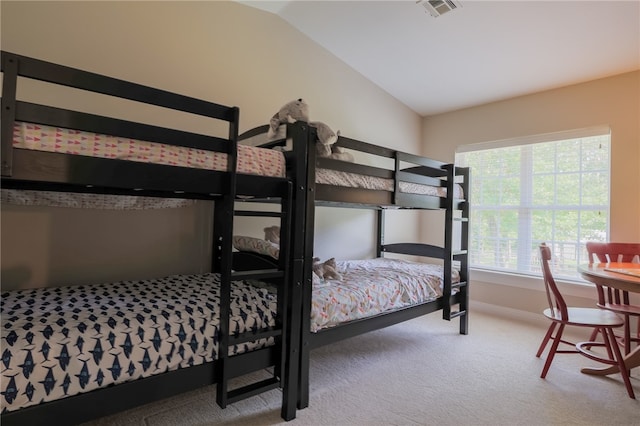 bedroom with carpet flooring and lofted ceiling