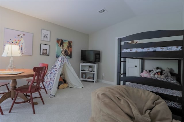 carpeted bedroom with lofted ceiling