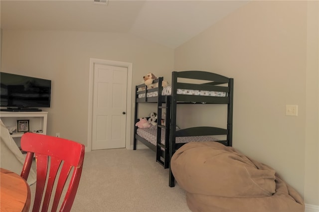 carpeted bedroom with lofted ceiling