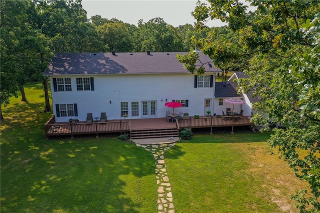 rear view of house with a lawn and a wooden deck