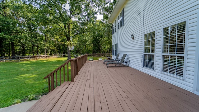 wooden terrace featuring a lawn