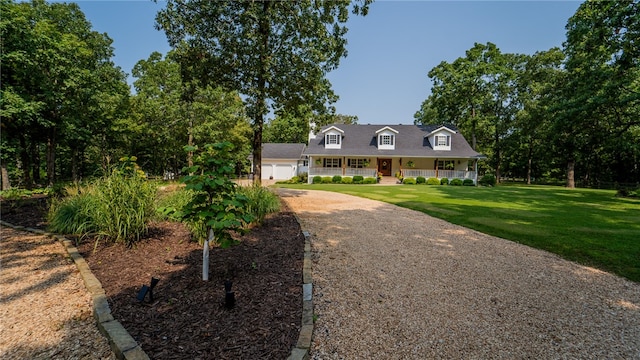 cape cod-style house featuring a garage, a front yard, and covered porch