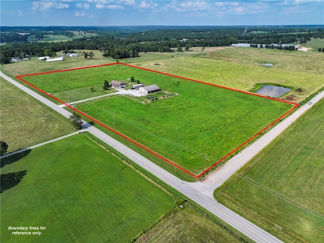 birds eye view of property with a rural view