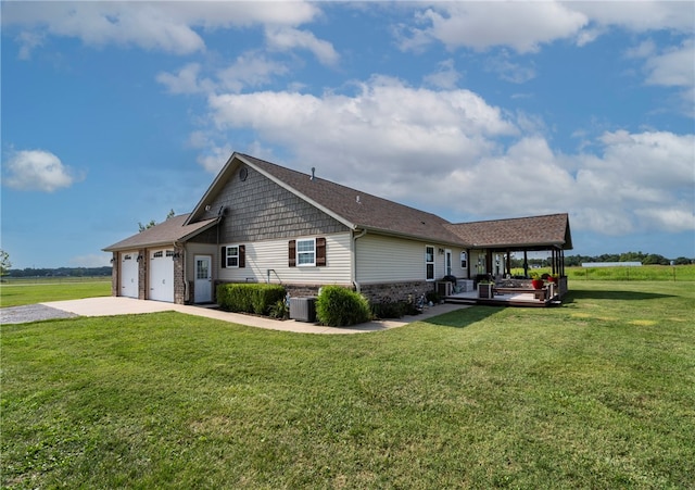 view of home's exterior with a garage, central air condition unit, and a lawn