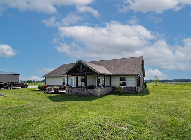 rear view of property with a lawn