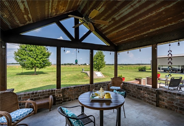 sunroom with ceiling fan and lofted ceiling