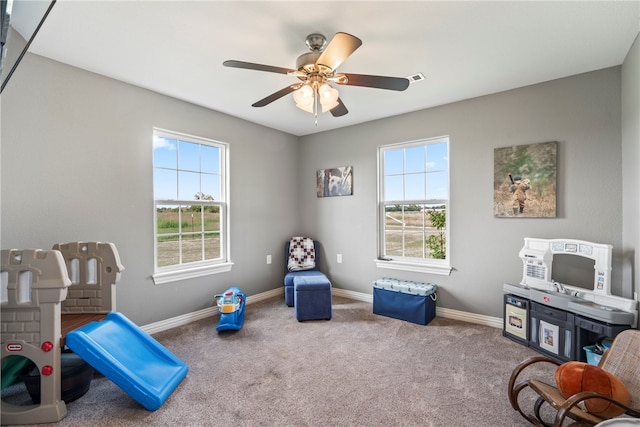 playroom with carpet, ceiling fan, and plenty of natural light