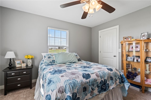 bedroom with ceiling fan and light colored carpet