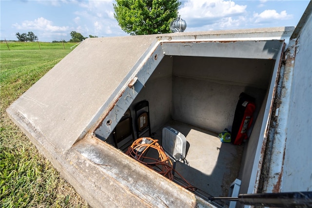 view of storm shelter featuring a lawn