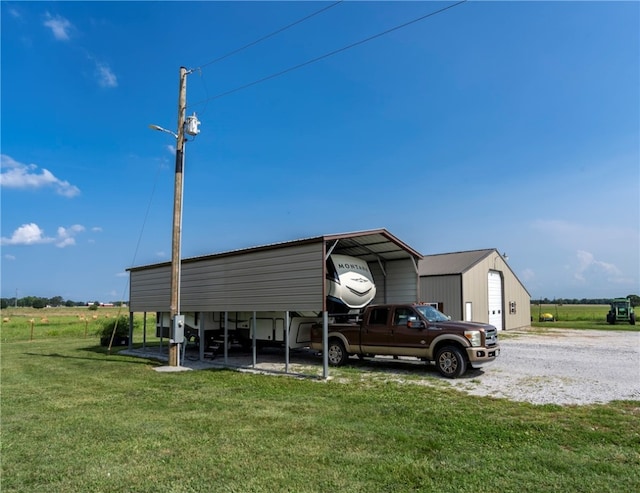 view of outbuilding with a carport and a lawn