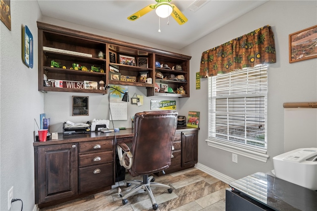 tiled office featuring ceiling fan and a healthy amount of sunlight