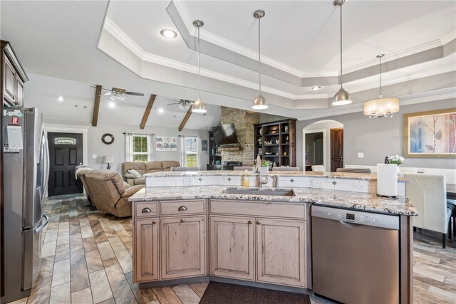 kitchen featuring a tray ceiling, ceiling fan with notable chandelier, beamed ceiling, sink, and appliances with stainless steel finishes