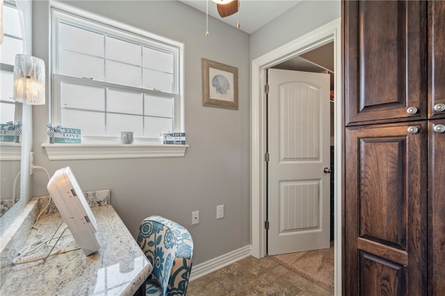 interior space with tile patterned flooring and ceiling fan