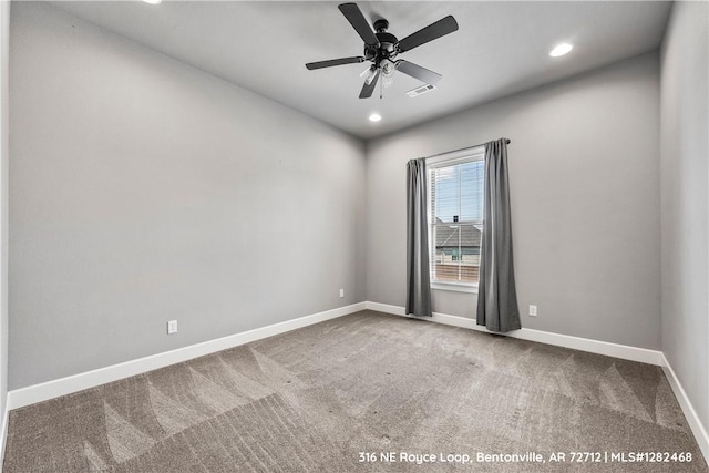 carpeted spare room with ceiling fan