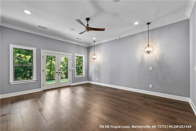 empty room with ceiling fan, dark wood-type flooring, crown molding, and french doors