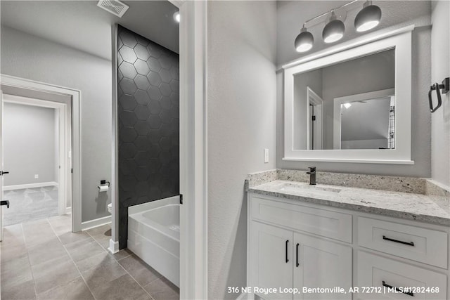 bathroom featuring tile patterned flooring, vanity, and toilet