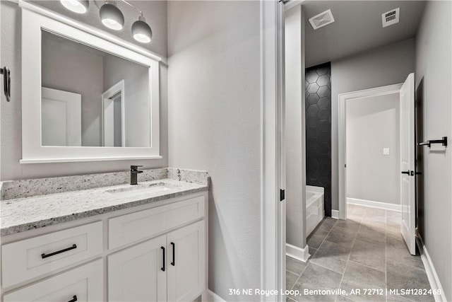 bathroom with tile patterned floors and vanity