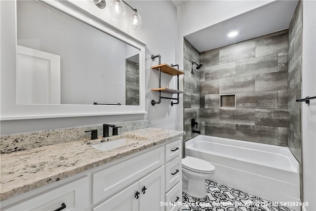 full bathroom with tile patterned floors, tiled shower / bath combo, toilet, and vanity