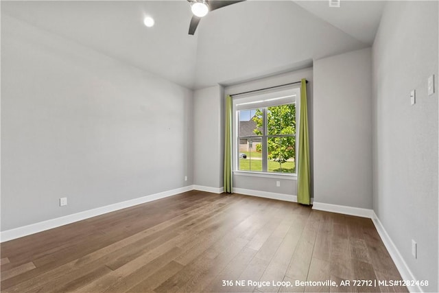 spare room featuring ceiling fan, high vaulted ceiling, and wood-type flooring