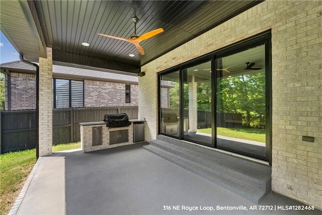 view of patio featuring an outdoor kitchen, ceiling fan, and a grill