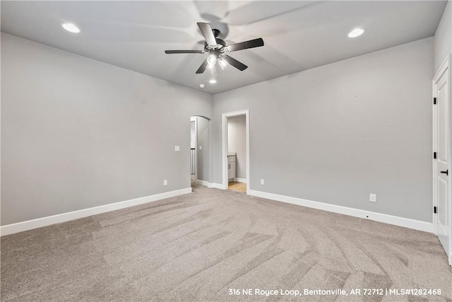 unfurnished room featuring ceiling fan and light carpet