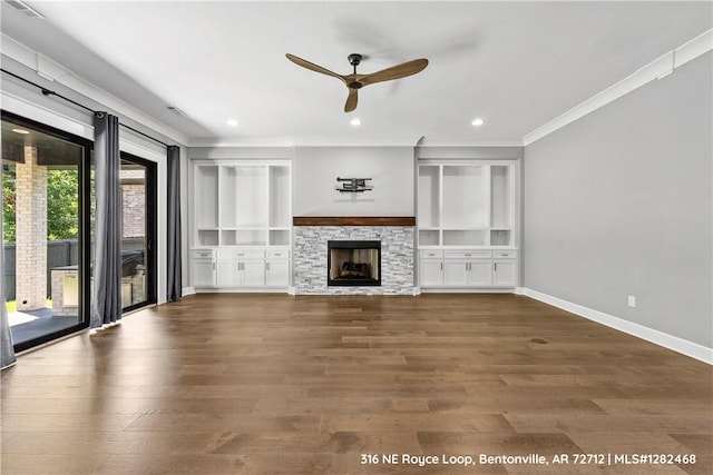 unfurnished living room featuring a fireplace, dark hardwood / wood-style floors, built in features, and ceiling fan