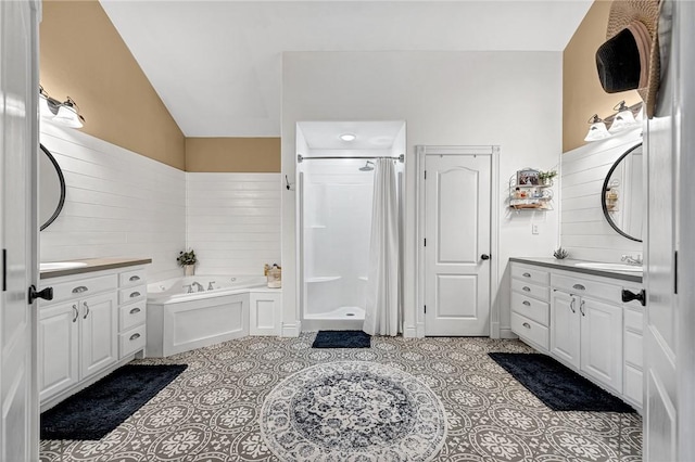 bathroom with vanity, tile patterned flooring, vaulted ceiling, and separate shower and tub