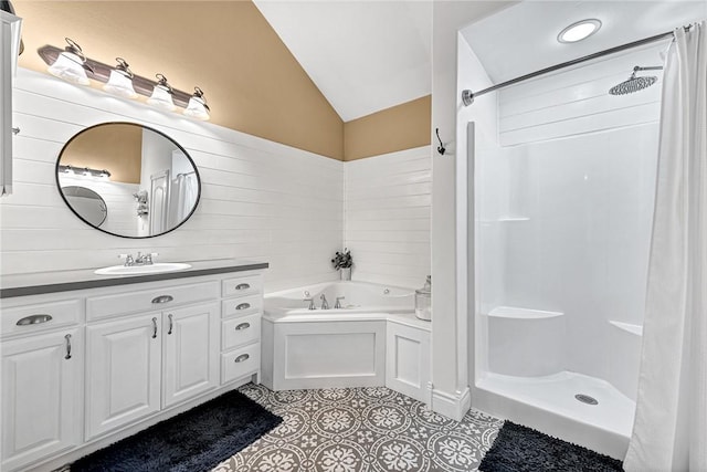 bathroom with tile patterned flooring, vanity, vaulted ceiling, and separate shower and tub