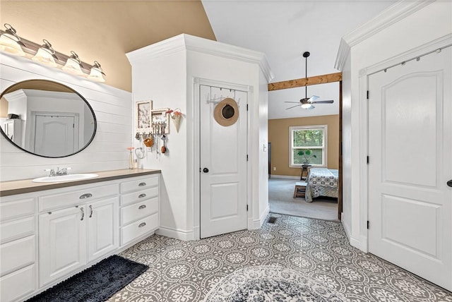 bathroom with tile patterned flooring, vanity, and ceiling fan