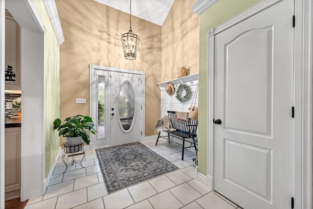 foyer with an inviting chandelier and light tile patterned flooring