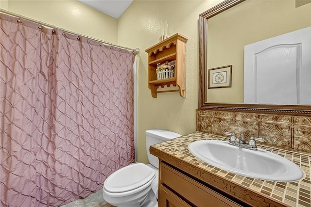 full bathroom with vanity, shower / tub combo, decorative backsplash, and toilet