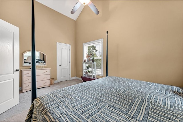 bedroom with ceiling fan, light colored carpet, and high vaulted ceiling