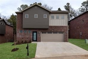 view of front of property featuring a garage and a front lawn