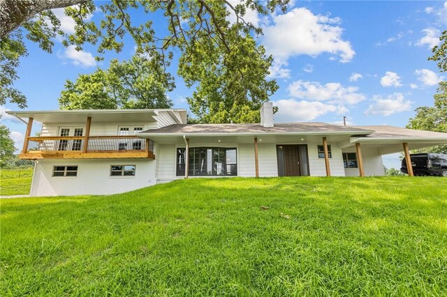 rear view of property featuring a yard