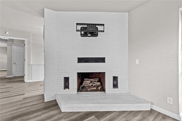 interior details with hardwood / wood-style flooring and a fireplace