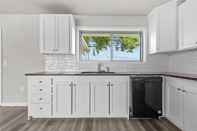 kitchen featuring sink, dark wood-type flooring, white cabinets, and black dishwasher