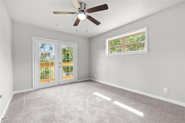 spare room with french doors, ceiling fan, and carpet floors