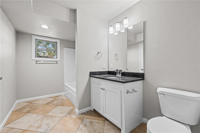 bathroom with vanity, a textured ceiling, and toilet