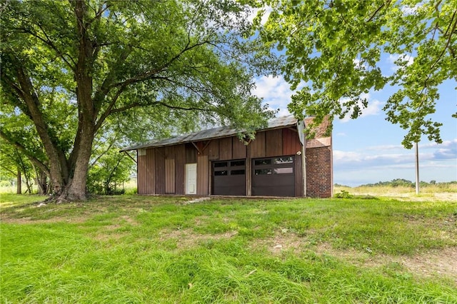 view of outbuilding with a garage and a lawn