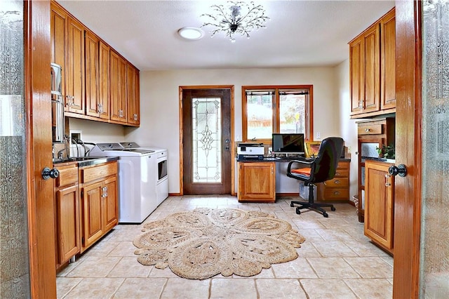 laundry room featuring cabinet space, washing machine and dryer, and baseboards