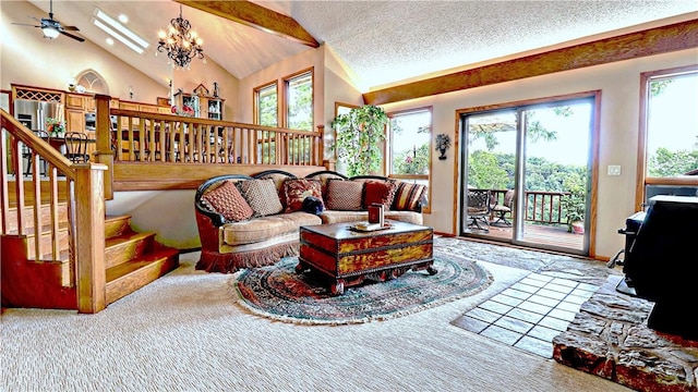 living room featuring a wealth of natural light, vaulted ceiling with skylight, a textured ceiling, and stairs