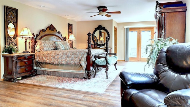 bedroom featuring access to exterior, a ceiling fan, and wood finished floors