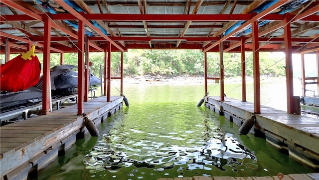 dock area with a water view and boat lift